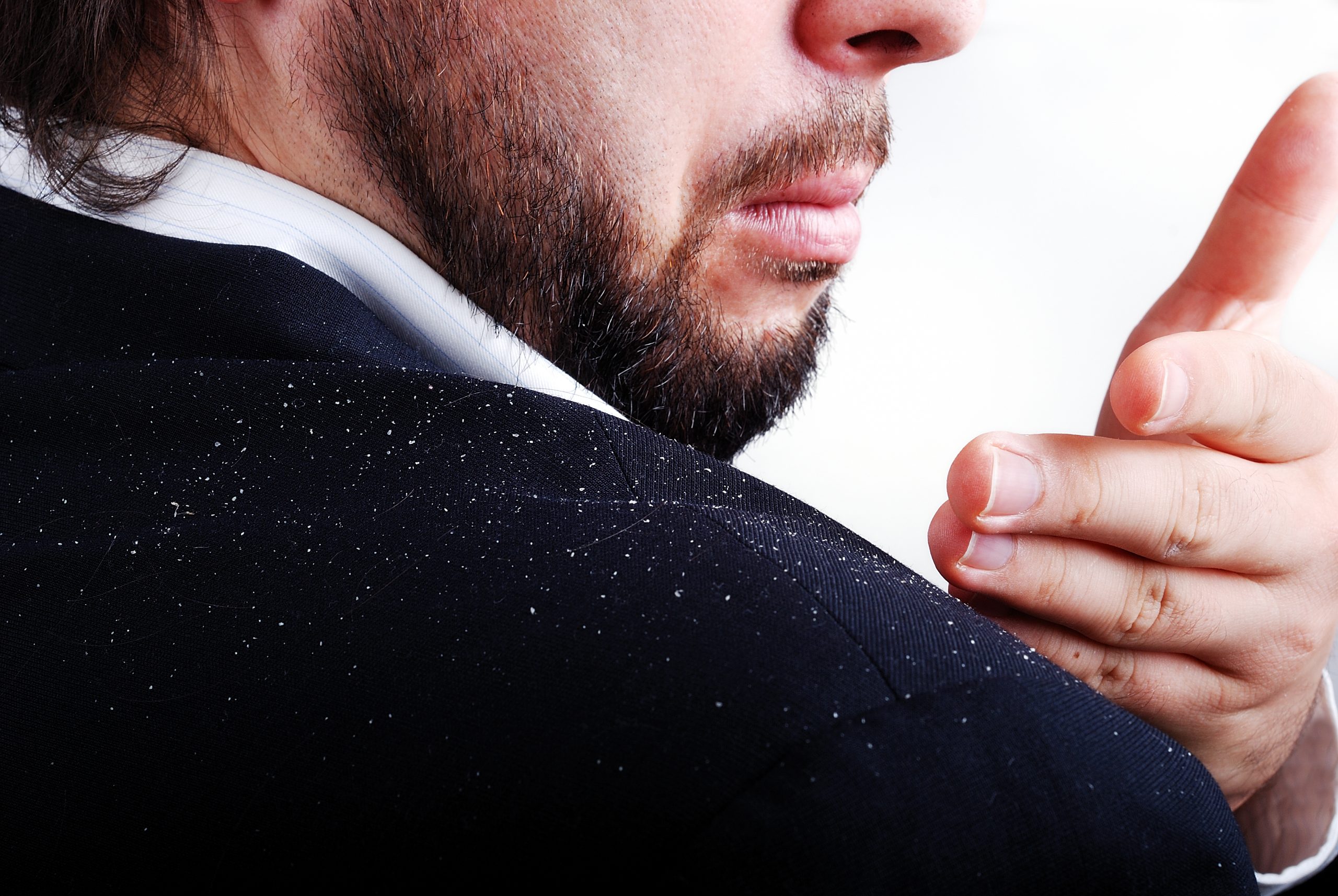 The man checking his shoulder for dandruff