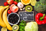 Vitamin C is written in a slate aurrounded by fruits and vegetables which are rich in vitamin c